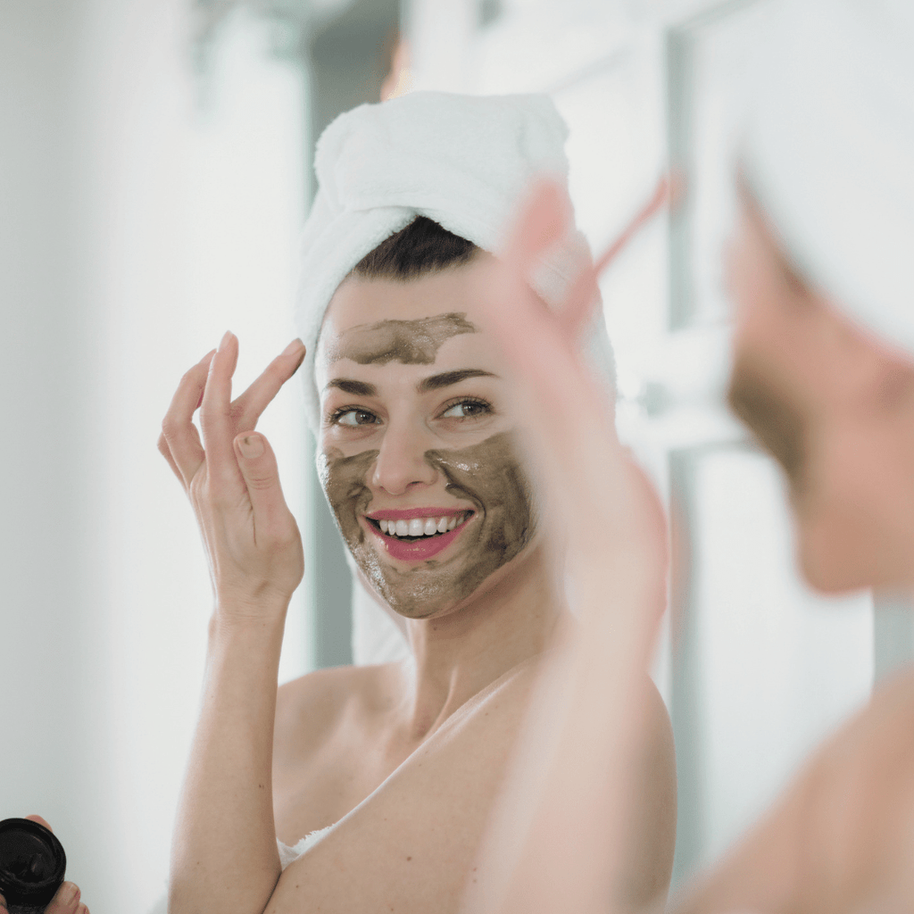 Woman applying a green facial mask, Super-food organic face mask by Inlight Beauty in front of a mirror.