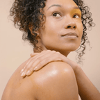 Woman applying organic body oil to her back and shoulder/ Inlight Beauty Firm & Tone oil for post - exercise