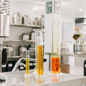 Lab with measuring cylinders of organic natural oils. Skincare raw ingredients.