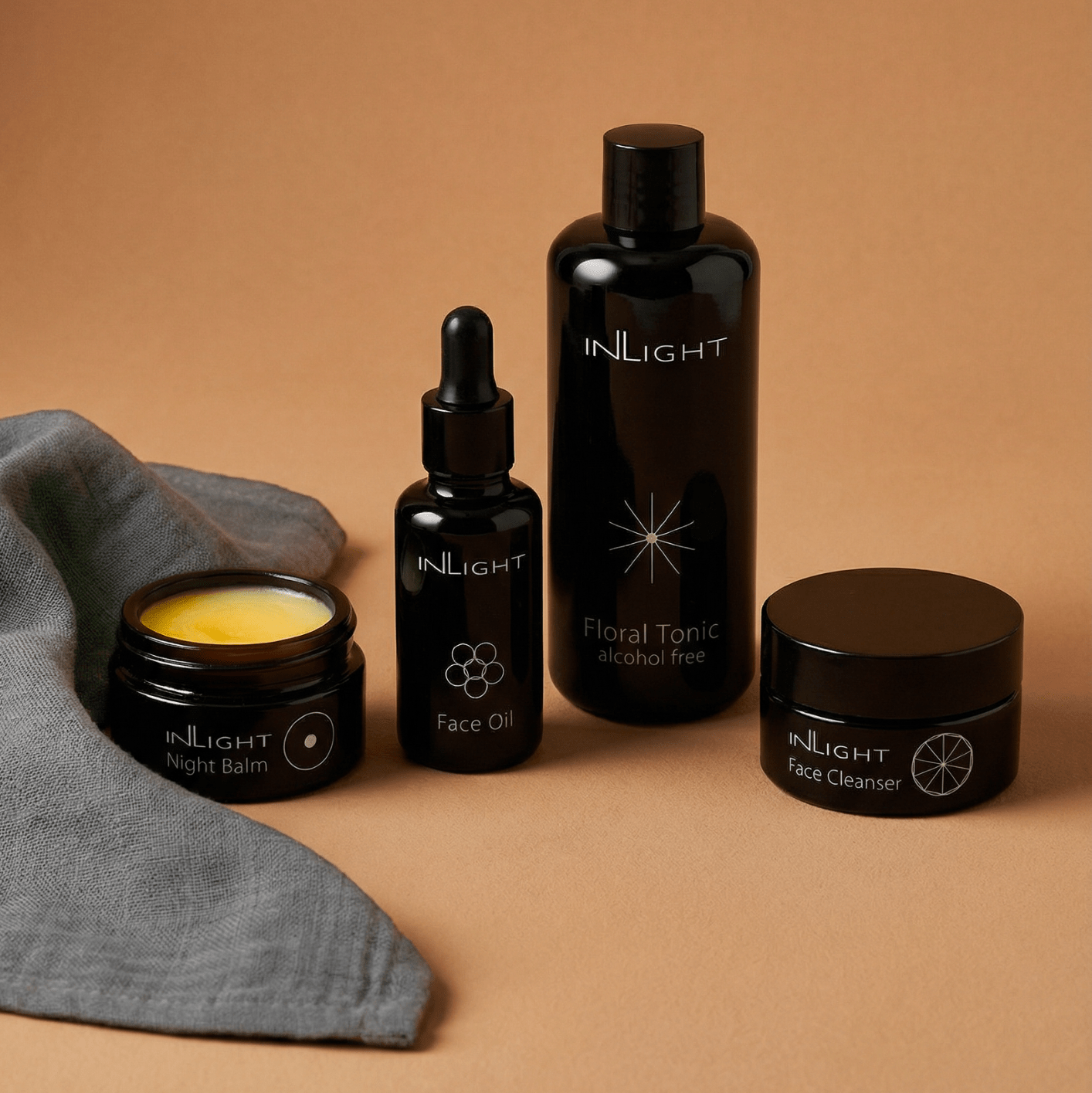 Inlight day and night bundle set featuring certified organic skincare in miron glass bottle with grey organic muslin cloth