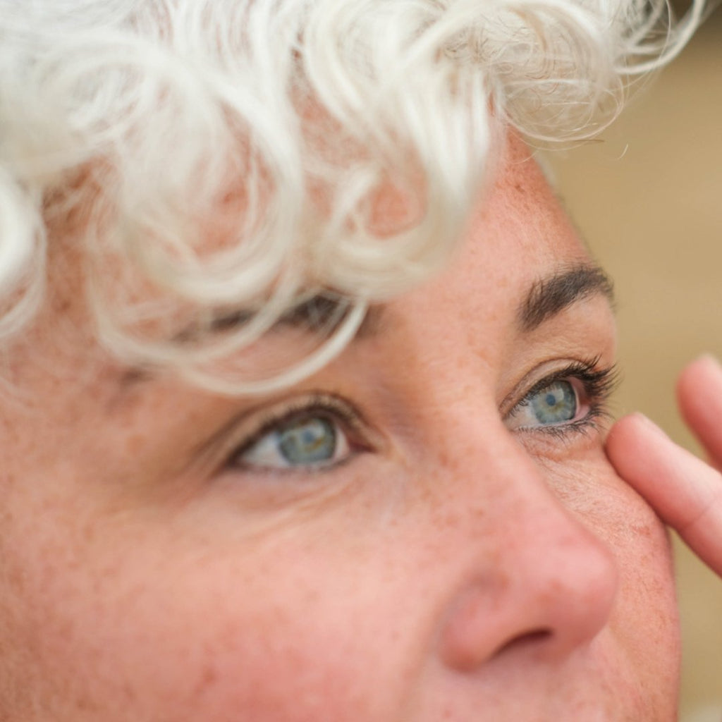 Inlight Organic Under Eye Revive Balm for tired, fatigued eyes. Model using eye balm