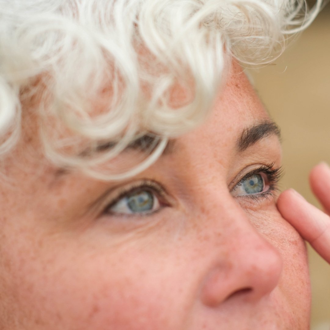 Inlight Organic Under Eye Revive Balm for tired, fatigued eyes. Model using eye balm